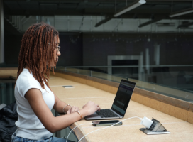 A student sitting taking a video call on a computer