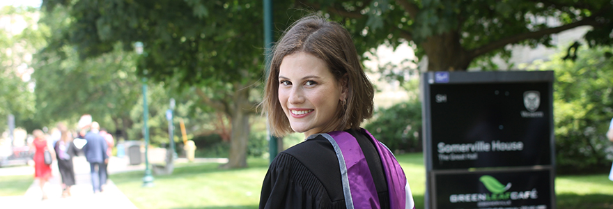 Graduate smiling over her shoulder