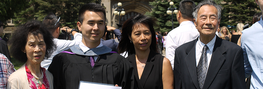 Graduate smiling with his family