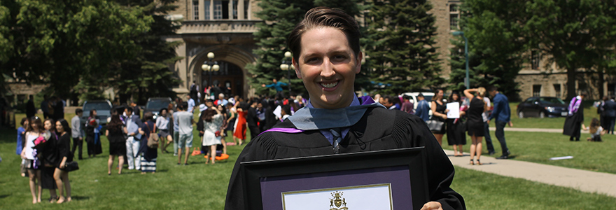 Graduate smiling with degree